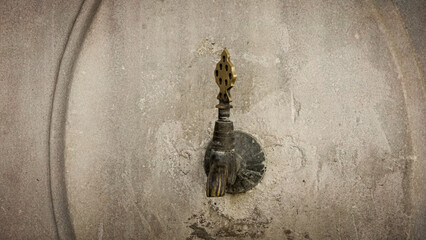 Close up view of brass faucet on public water fountain with its old marbel wall, Public bronze faucet fountain in old Ottoman  traditional style. city Istanbul