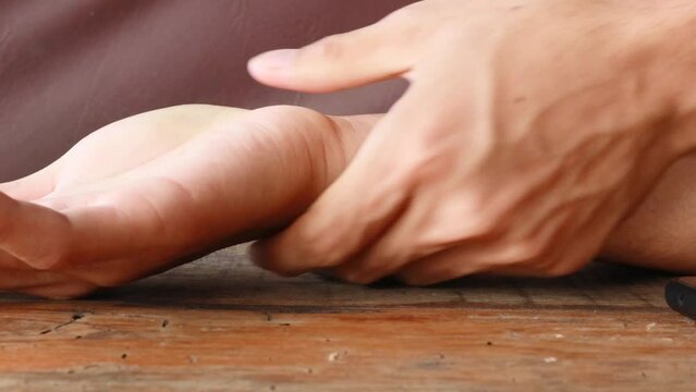 Close up of human hand massages his arm out of pain. System for limbs numbness, physical injury. Concept of health problem