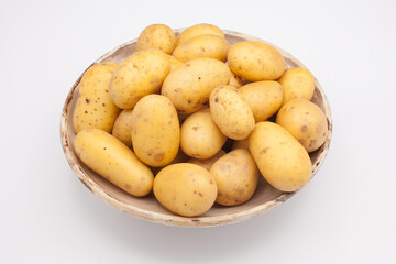 A bowl of new potatoes against a white background