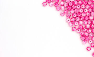 close-up pink beads, selective focus with blur effect, background for handicrafts and jewelry, DIY jewelry beads. top view frame