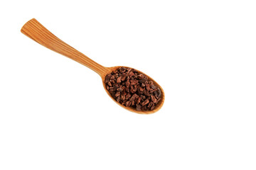 Cocoa nibs in wooden spoon, close-up. Selective focus, Design element. Sugar-free product,  Natural antidepressant. Cacao nibs are often added to cereals, smoothies, desserts, and drinks