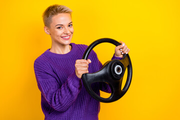 Portrait of toothy beaming woman with short hair violet sweater hold steering wheel buy new car...