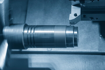 The CNC lathe machine thread cutting at the metal shaft parts.
