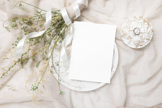 Blank card mockup with gold ring and will flowers