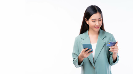 Young Asian businesswoman using credit card for making payment in mobile phone isolated on white background Smiling young girl purchasing online through phone by using credit card online payment