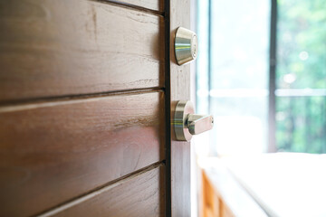 Wooden teak door open to modern new house bedroom