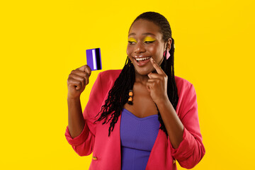 Black Female Holding Credit Card Dreaming About Shopping, Yellow Background