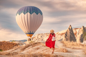 The air was alive with the sight of the balloons hovering in the sky above, and the girl below them in her red dress shining in the sunlight. She stood there, captivated.