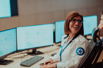 Female security operator working in a data system control room offices Technical Operator Working...