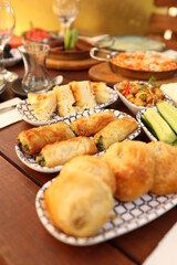 a table with a variety of food items on it and a tea glass on the side of the table