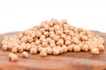 A pile of chickpea in a wooden plate, isolated on white backround