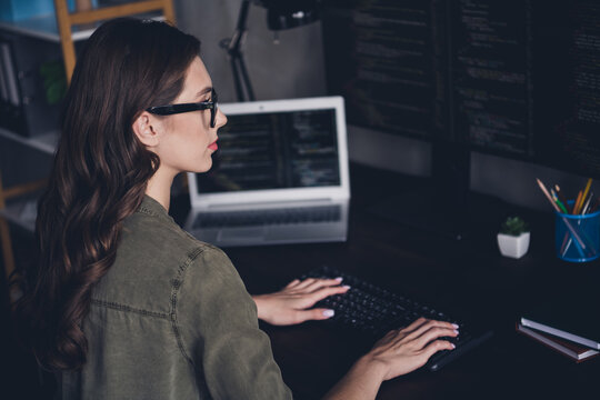 Photo of confident serious lady programmer wear eyeglasses creating modern gadget application indoors workplace workstation