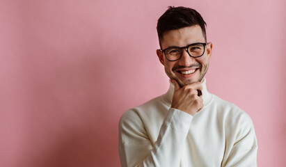 Portrait of happy bearded man wearing eyeglasses laughing and looking camera while posing