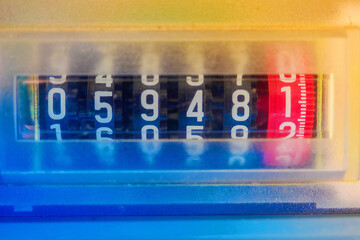 Close-up electric meter figures. Control of power consumption. Topic of tariff increases..