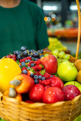 basket of fresh fruits, strawberries, apples, grapes, blueberries and raspberries