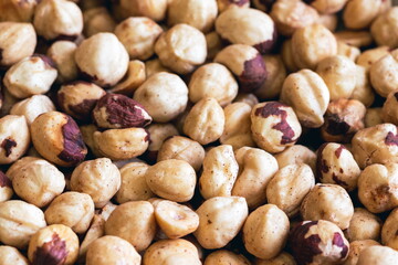 Peeled hazelnuts. Poorly peeled hazelnuts. Background of peeled hazelnuts.