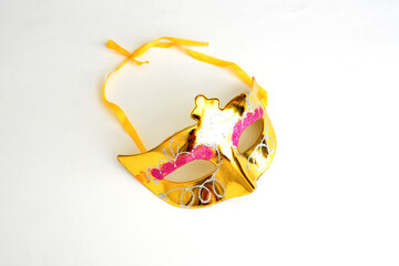 golden carnival mask with sprinkles isolated on white background, close-up