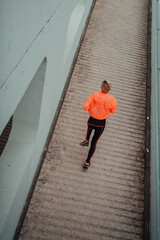 Top view photo of omen in sports clothes running in a modern urban environment. The concept of a sporty and healthy lifestyle