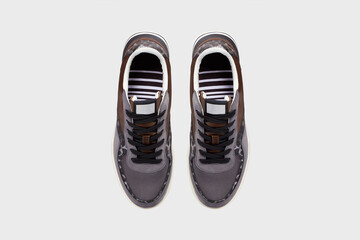 Grey leather male slip-on tennis skate sneakers in leopard print. Pair of sports training shoes for gym running isolated on white background. View from above. Template, mock up