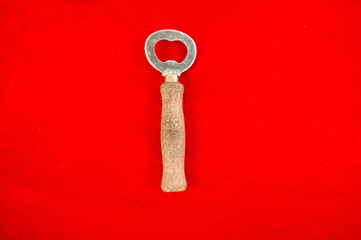 Bottle opener on red background.