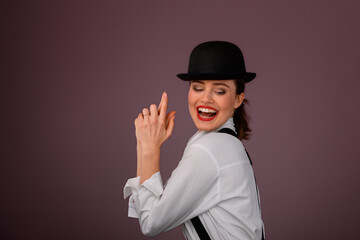 Portrait of happy young woman in hat, studio shoot.