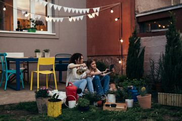 Caucasian mother and daughter are sitting in the garden