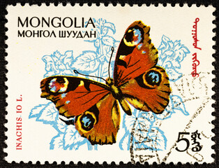 Fototapeta na wymiar MONGOLIA - CIRCA 1963: Postage stamp issued in Mongolia with the image of the Peacock Butterfly, Inachis io.