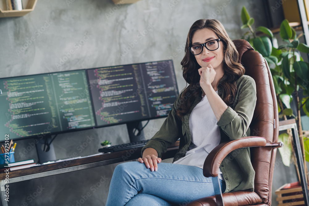 Wall mural photo of smiling clever lady coder dressed glasses solving bugs modern device indoors workstation wo