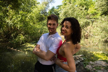 Fototapeta premium Young couple of Latin dancers, handsome and in love are walking in the park while showing their love. Woman and man are happy, in love and love each other. Love concept.