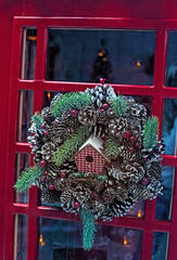 Fototapeta na wymiar Fairytale Christmas door with wreath and lights