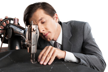 Confident young tailor sewing clothes in the tailor shop