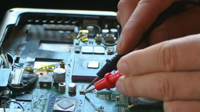 Hands fixing motherboard of pc or laptop notebook close up in service