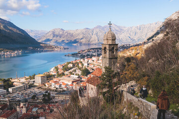 Fototapeta na wymiar Church of Our Lady of Remedy in Kotor, Montenegro, beautiful top panoramic view of Kotor city old medieval town seen from San Giovanni St. John Fortress, with Adriatic sea, bay of Kotor and mountains