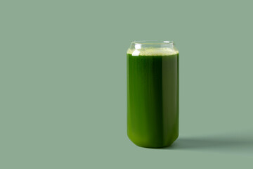 Celery juice in a glass on a green background