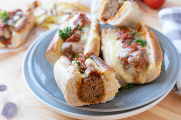 Italian meatball sandwiches with tomato sauce and cheese on a plate
