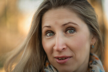 Portrait of a beautiful blonde girl close-up outdoors.