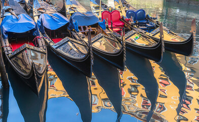Fototapeta na wymiar Closeup of gondolas in Golden sunset, Venice