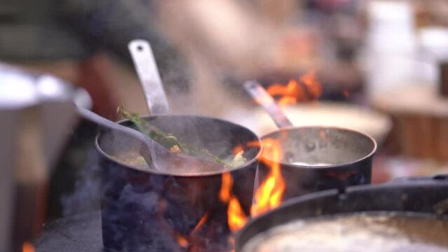 Boiling tee in a pot mug on fire, in the forest in the fresh air