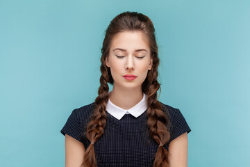 Attractive beautiful calm woman with braids standing with closed eyes, having problems with eyesight
