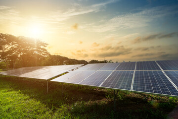 Photovoltaic modules solar power plant on dramatic sunset sky background,clean Alternative power...