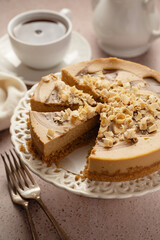 Caramel cheesecake sliced and served with cup of tea