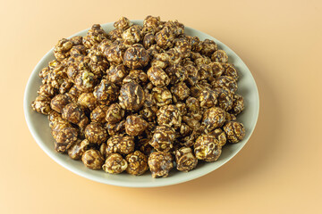 A full bowl of popcorn with caramel and cocoa frosting