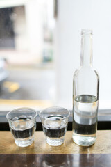Glass bottle with 2 cup of glass fill with water