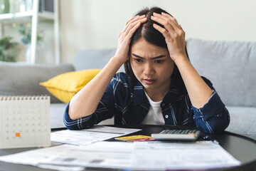 Business financial concept, owe asian young woman, female sitting expression face stressed by calculate expense on table from invoice or bill, have no money to pay mortgage or loan. Debt, bankruptcy. - obrazy, fototapety, plakaty