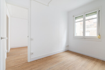Bright white spacious unfurnished apartment with an window and wooden textured laminate. Concept of...