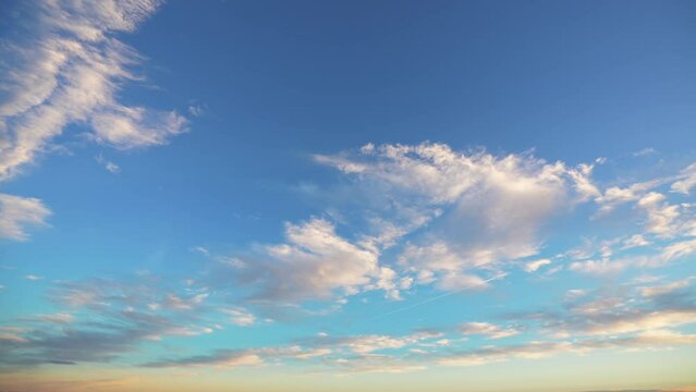4k sunset time lapse video. Wide angle view of the amazing vivid color sky with cumulus and cirus clouds during a spring sunset.