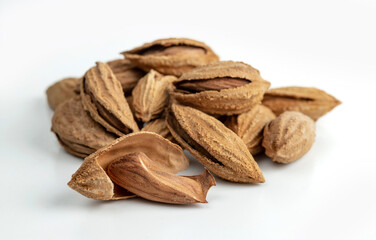 Almond kernels and shell almonds isolated on white background. Selective focus...