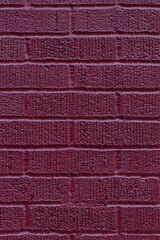 Fototapeta premium Close up of painted burgundy brick wall texture background