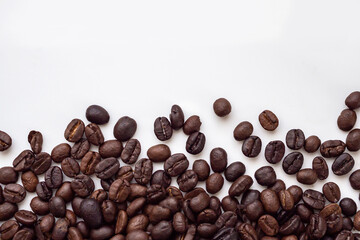 Fresh roasted brown coffee beans on white background