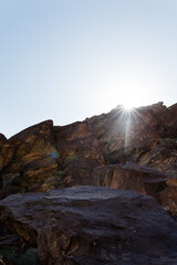 Sunlight streaming above desert rock in Tahquitz Canyon in Southern California in the Coachella Valley near Palm Springs.